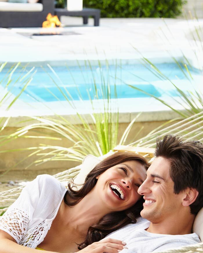 Young couple celebrating their new pool and patio project completion in Fort Pierce