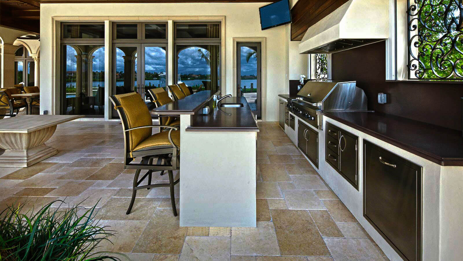 Slide Luxury outdoor kitchen with stone countertops and built-in appliances - Custom outdoor living spaces
