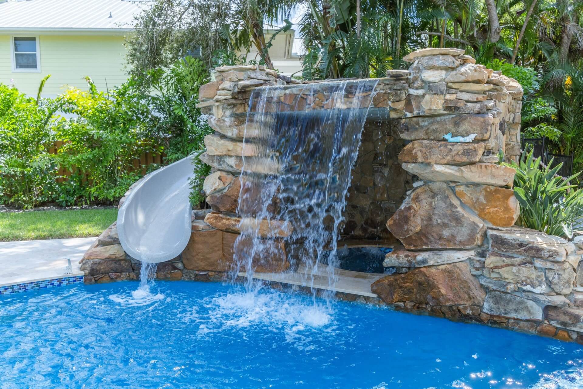 Recreational pool with water slides and interactive play features for families in Jupiter