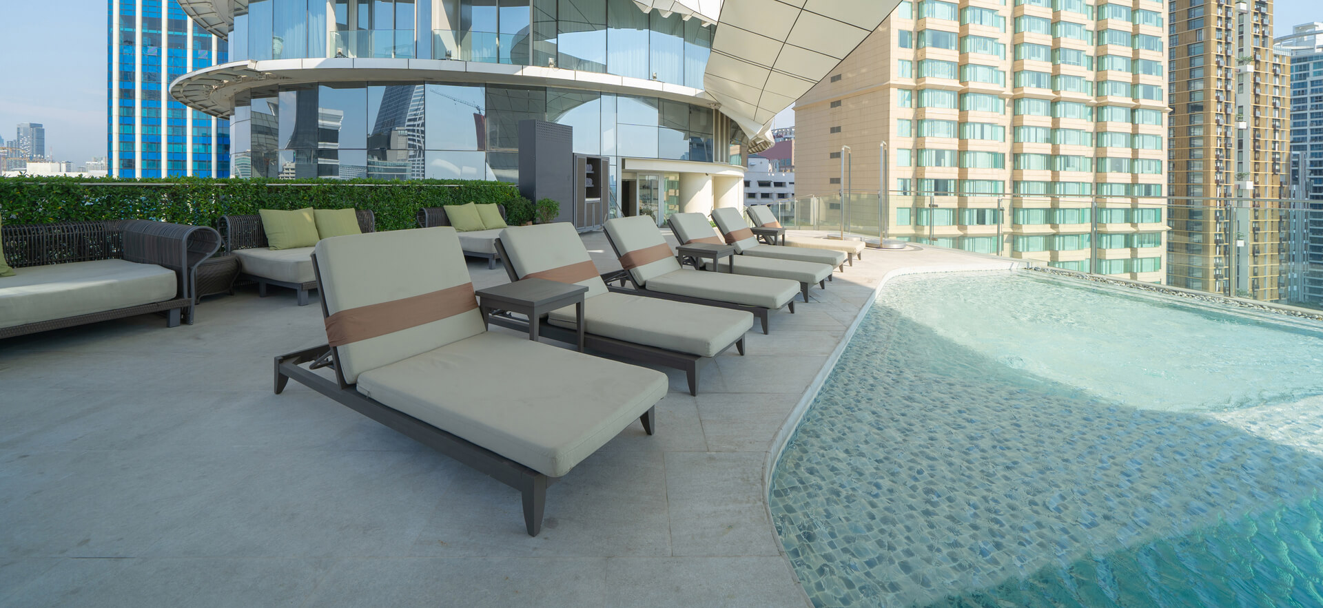 Commercial pool deck materials including concrete and natural stone options in Jupiter
