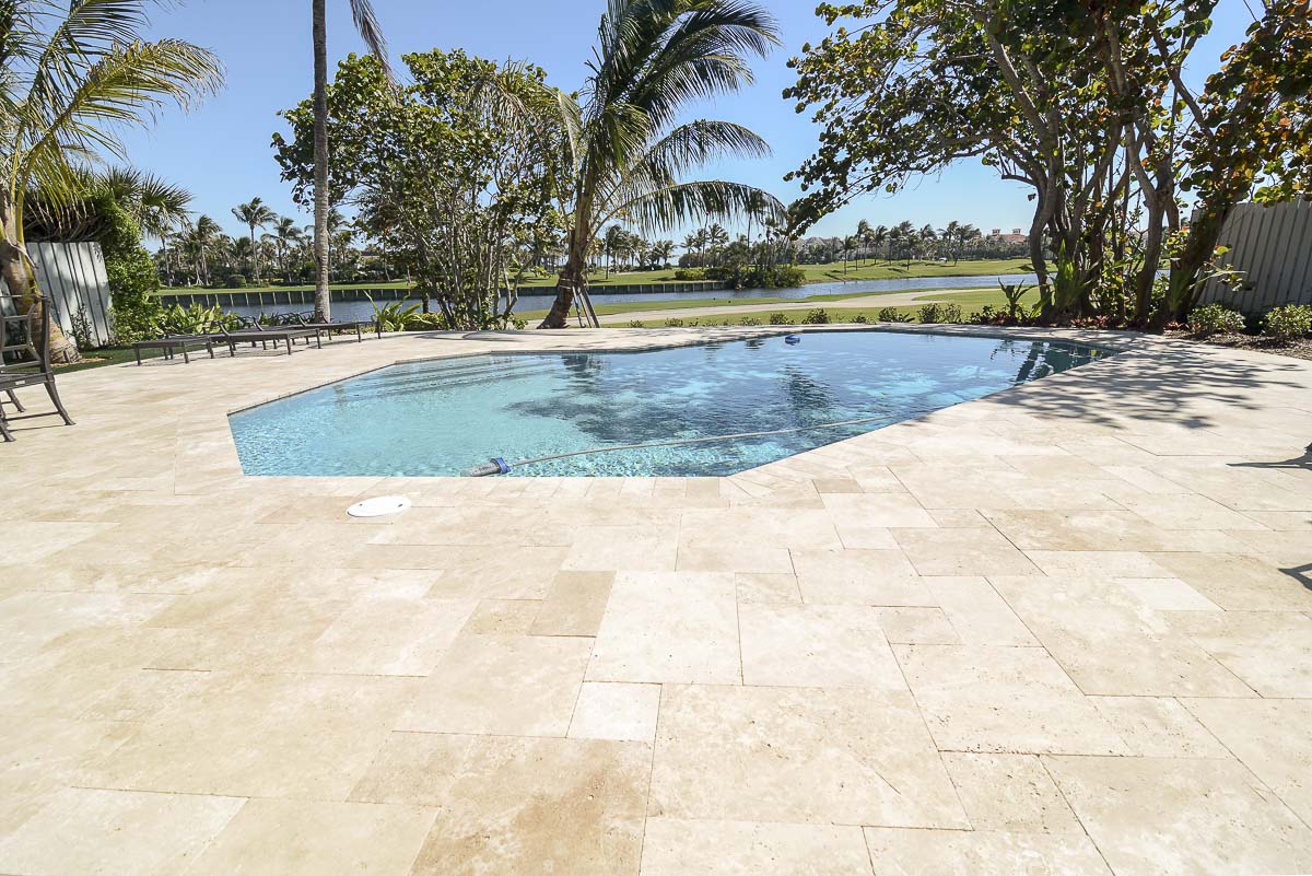 Professional pool deck installation with elegant paver design