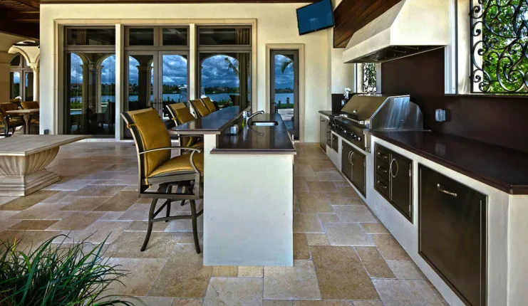 Luxury outdoor kitchen with stone countertops and built-in appliances - Custom outdoor living spaces