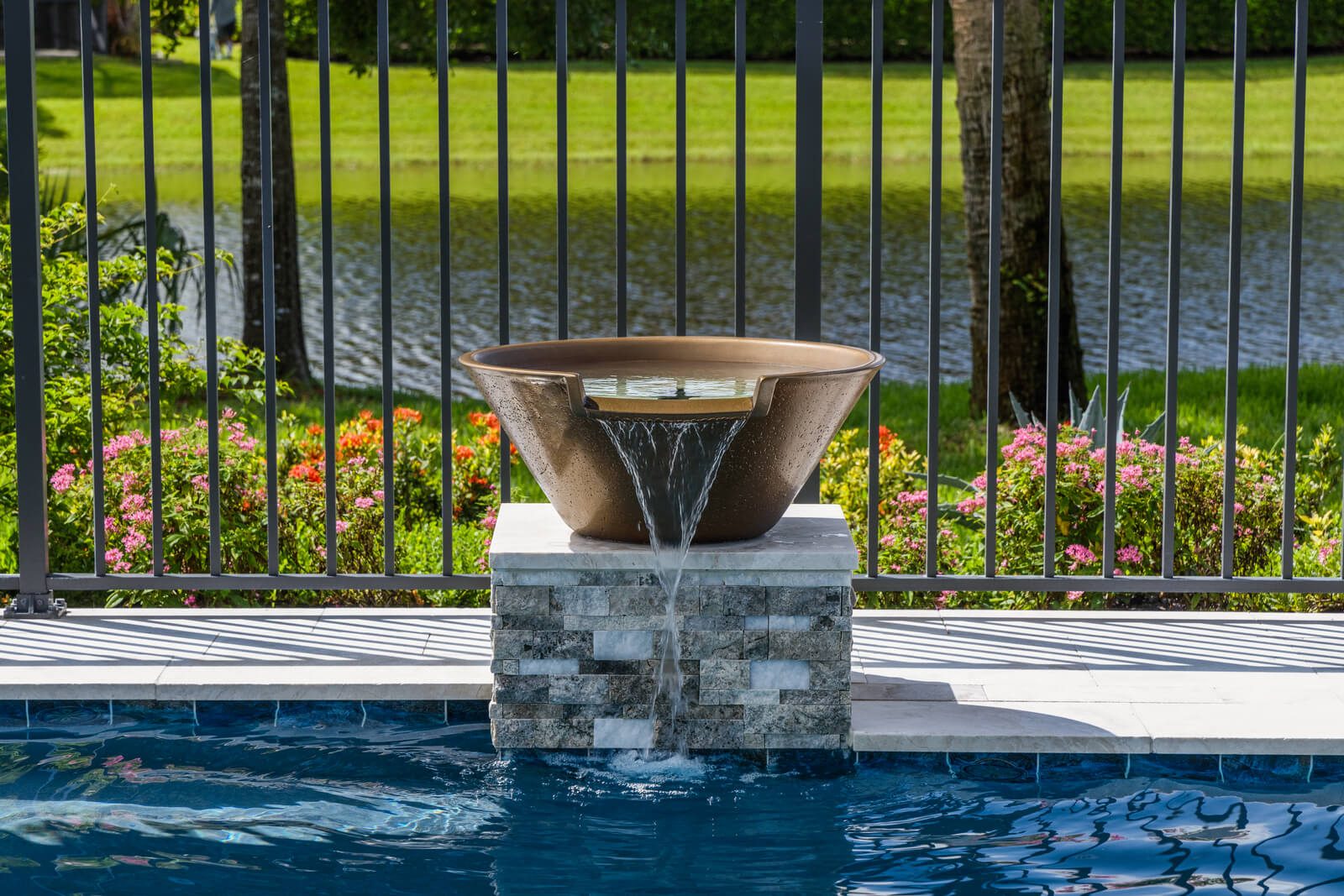 Custom pool with cascading waterfall features and natural stone design near you in Florida
